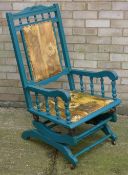 An early 20th century green painted rocking chair