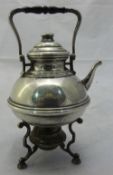 A silver miniature kettle on stand