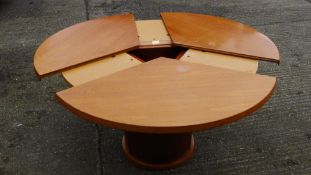 A Skovby patent circular extending dining table