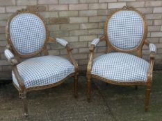 A pair of 19th century French gilt framed open armchairs