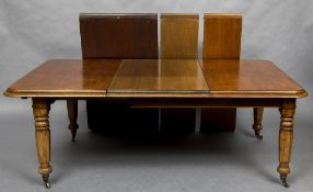 A Victorian mahogany pull-out extending dining table The moulded rectangular top incorporating four