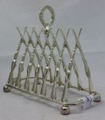 A silver plated gun form toast rack