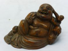 An early 20th century carved wooden model of Buddha