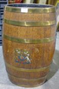 A brass bound crested oak barrel