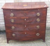 An inlaid mahogany bow front chest of drawers with a brushing slide
