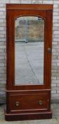 A Victorian mahogany single door mirrored wardrobe