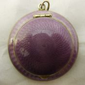 A silver and enamel purple compact