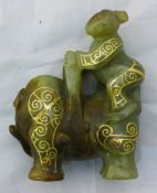 A gold inlaid jade figure