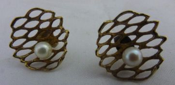 A pair of gold pearl earrings