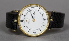 A Sarcar 18 ct gold wristwatch The white circular dial with Roman numerals and batons. 3 cm wide.
