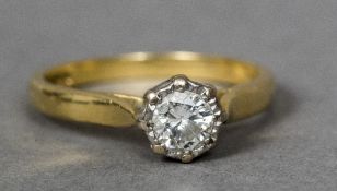 An 18 ct gold diamond solitaire ring The illusion set stone spreading to approximately 0.