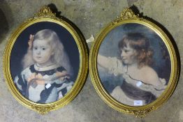 A pair of oval gilt framed prints