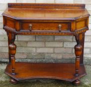 An early 20th century oak single drawer side table