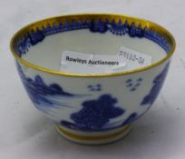 A small blue and gold rim tea bowl