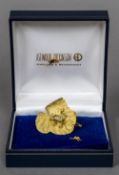 A boxed Astwood Dickinson 18 ct gold diamond set brooch Formed as a frog on a lily pad. 3.