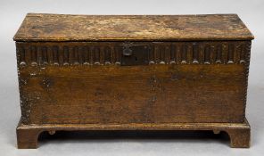 A 17th/18th century oak plank coffer The front panel with short gadrooned decoration,