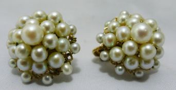 A pair of gold pearl earrings