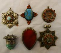 Six Eastern coral and silver pendants