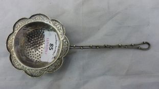 A unmarked Chinese silver tea strainer