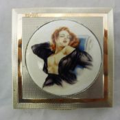 A Deco silver compact mounted with a plaque depicting a young lady