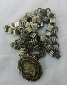 A Victorian gold inset silver locket and collar chain