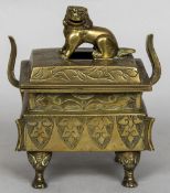 A Chinese bronze twin handled censor The pierced cover with temple lion finial,