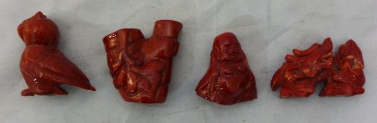 Four carved coral figures