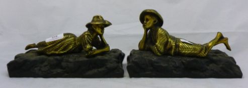 A pair of bronze boy and girl figures