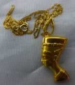 A gold Egyptian pendant and chain