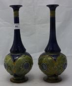A pair of Doulton Lambeth stoneware bottle vases decorated with classical bust roundels