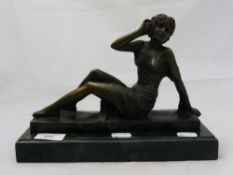 A bronze in the form of a seated nude