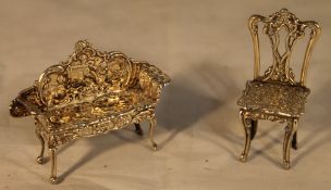 A miniature silver settee and chair