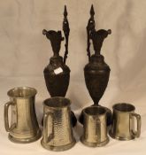 A pair of pewter ewers and plated tankards