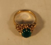 A 9 ct gold green stone set ring