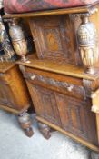 An early 20th century carved oak side cabinet