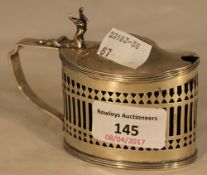 A silver oval mustard pot