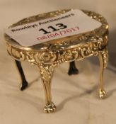 A miniature silver oval table