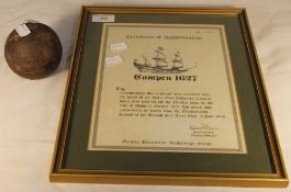 An antique cannon ball and certificate