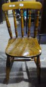 A Victorian elm seated stick back chair