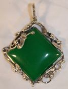 A silver and jade pendant