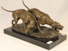 A bronze figure formed as two dogs