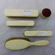 A quantity of late 19th/early 20th century ivory brushes and a pin cushion