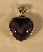 A silver and amethyst heart pendant