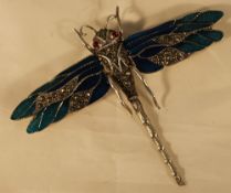 A silver dragonfly brooch