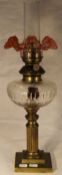 A brass and glass oil lamp