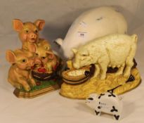 Two pig form door stops and two model pigs