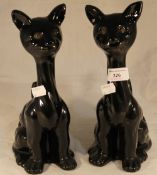 A pair of stylised porcelain cat figures
