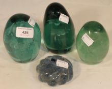 Three Victorian glass dump weights and a Victorian paperweight