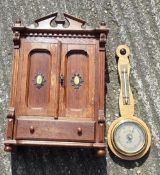 An oak miniature wardrobe and a barometer