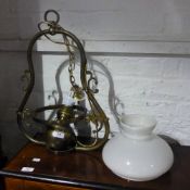 A converted brass hanging oil lamp with a milk glass shade